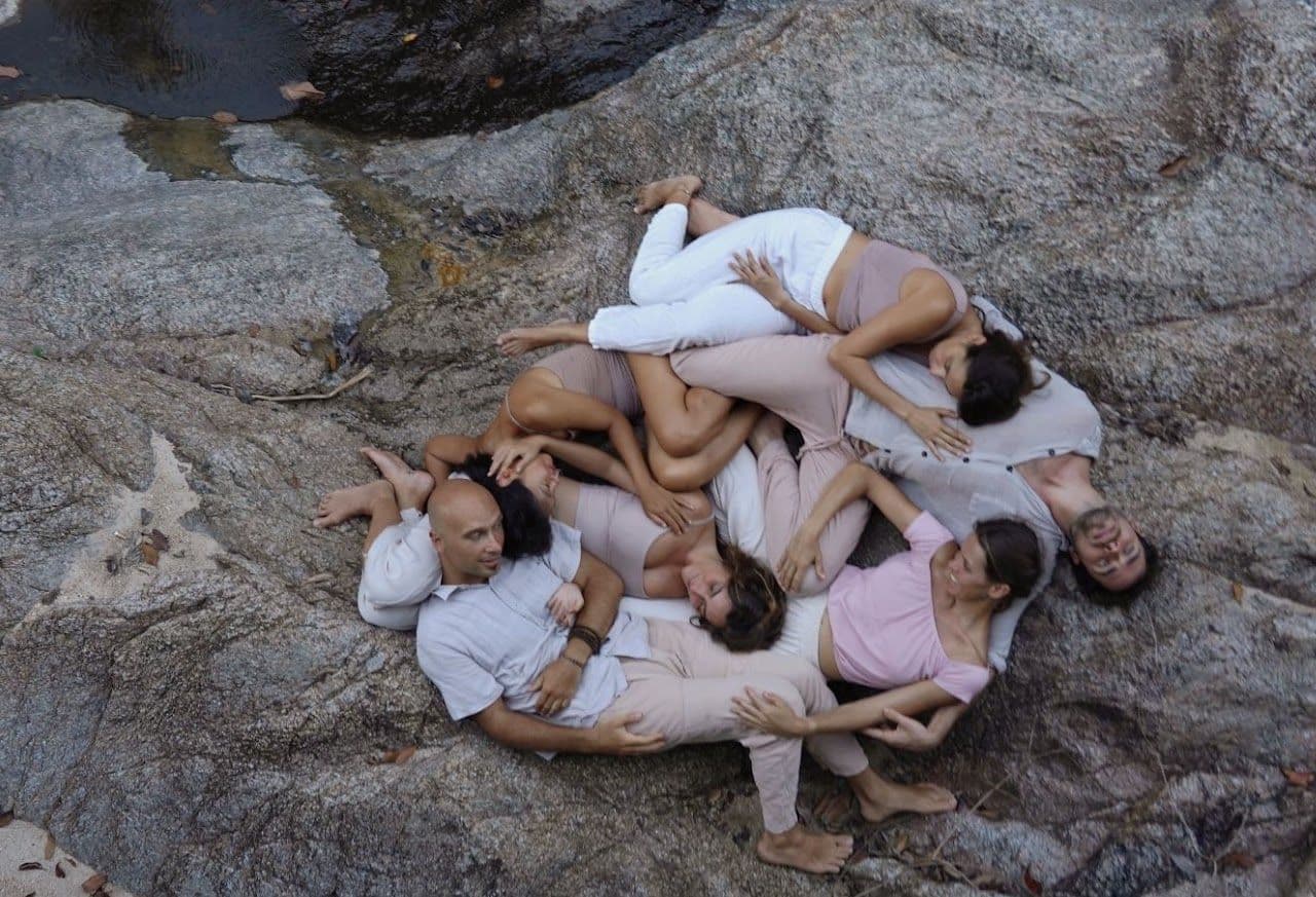 A group lying close together on a large rock.